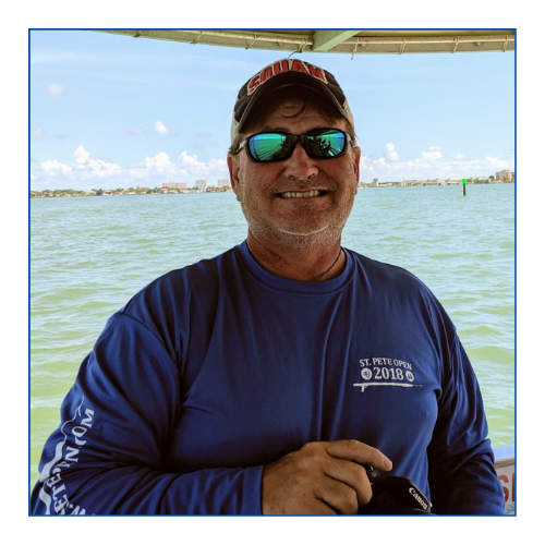 a man standing next to a body of water