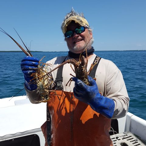 a person standing next to a body of water