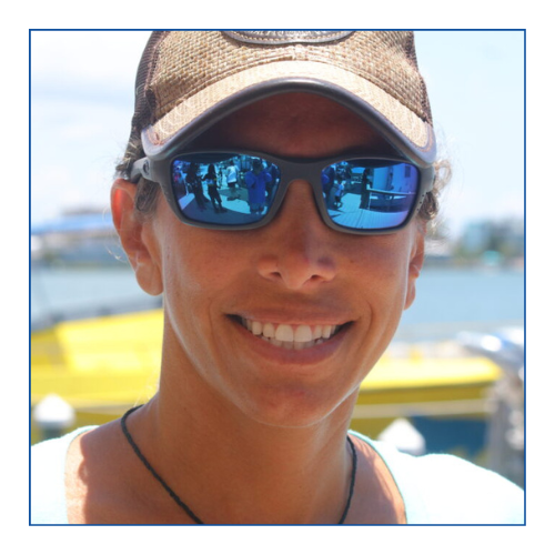 a woman wearing sunglasses posing for the camera