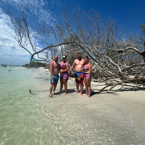 a group of people riding skis across snow covered ground