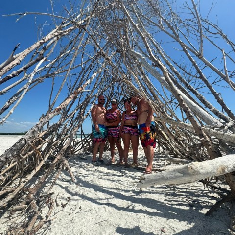 a group of people standing next to a tree