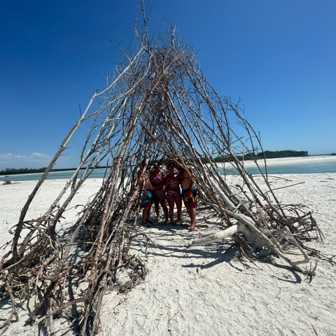 a group of people standing next to a body of water