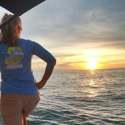 a person standing next to a body of water